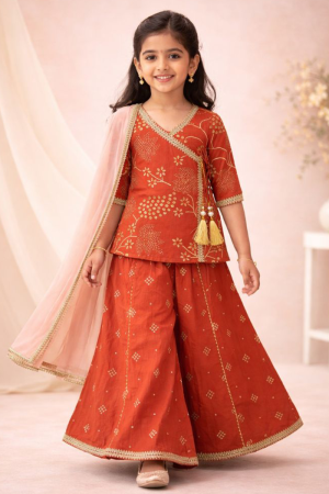 Girl wearing rust orange Angrakha kurti palazzo set with dupatta in Cotton festive ethnic wear for kids
